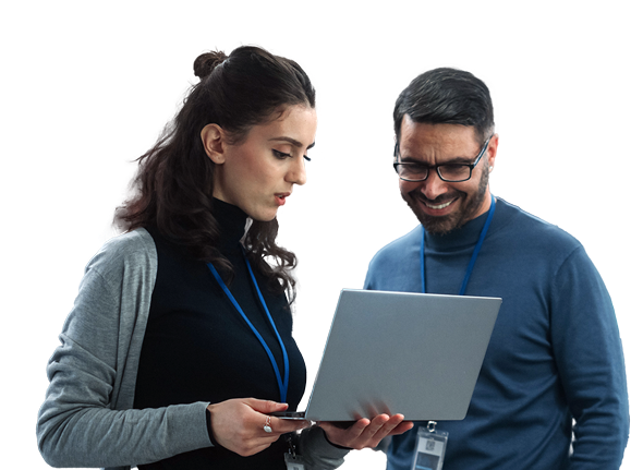 A woman and a man, both wearing ID badges and dressed in professional casual clothing, are looking at a laptop. The woman is holding and pointing at the laptop while the man smiles, suggesting a collaborative work discussion or review. A woman and a man, both wearing ID badges and dressed in professional casual clothing, are looking at a laptop. The woman is holding and pointing at the laptop while the man smiles, suggesting a collaborative work discussion or review.